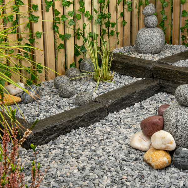 blue grey pebbles with large Mediterranean boulders in modern garden