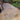 buff brown porcelain paving tiles laid in garden with artificial grass