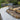 Garden with gravel pathway, raised wooden beds, and outdoor furniture.