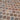 Close-up of a patterned stone floor with various shades of brown and gray.