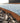 Close-up of CORE Flexible Steel Edge, Cor-Ten ﻿ with wood chips on a gravel surface