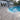Pool area with tiled porcelain patio stones and house in the background