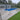 In-ground pool with wooden porcelain paving slabs and house in the background
