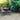 Outdoor patio set with table and chairs surrounded by greenery on a stone patio; DISCOUNTED Crossover White Porcelain Paving, 900 x 600, 8.64m - Only 1 Pack Available