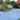 DISCOUNTED Quartz Grey Porcelain Paving, 600 x 600, 6.48m - Only 1 Pack Available; Paved patio area with a raised garden bed containing plants and flowers.