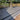 Gray stone patio with a tree and wooden fence in the background