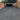 Driveway with a brick garage and house in the background