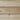 Close-up of light natural wood planks with visible grain, knots, and horizontal seams.
