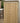 A tall wooden garden shed with double doors and side louvered panels, shown outdoors next to a white wall and fence.