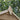 Wooden roof peak with green foliage in the background