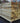 Stack of wooden planks with a blurred outdoor background