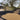 Residential driveway with black geotextile fabric and gravel, house in the background