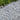 Ice Blue Chippings with green plants in the background
