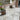 Outdoor porcelain patio with modern grey tiles, garden furniture, and plants.
