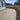 'Natural' Raj Green Porcelain Paving; mixed sized patio pack of beige tiles; with brown decorative stones border and black jointing