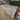 Paved patio area with a garden and shed in the background