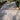 Gray stone patio with wooden border in a garden setting