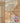 A collage of stone-look porcelain tile samples in warm beige, tan, and light brown tones, with a circular 'Stone Zone 15 Year Guarantee' badge in the lower right corner.