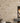 Beige stone wall with a fireplace
