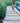 Wooden steps leading to a garden with gravel and greenery