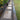 Garden pathway with stepping stones and gravel, surrounded by greenery.