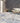 spectrum tiles grey marble tiled floor, wooden furniture, and brick wall.