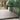Composite deck with black railing leading to a glass door entrance.