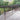 Composite Wooden deck with metal railing in a garden setting