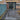 Paved patio area in front of a house with glass doors leading to an indoor space.