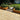 Paved patio area with wooden raised garden beds and a shed in the background