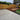 Backyard with a newly paved patio area, wooden play区, and grassy area.