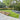 Garden with paved area, grass, and wooden planters