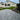 Paved patio area with grass lawn and house in the background