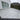 Paved patio area in front of a house with a cloudy sky.