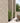 Outdoor patio area with stone wall, potted plants, and wicker furniture.