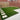 Backyard with grass area, paved patio, and wooden fence.