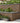 Decorative stone wall with garden plants and steps leading up to it