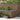 Decorative stone wall with garden plants and steps leading up to it