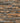 Pattern of stacked stone tiles in brown and gray tones.