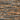 Pattern of stacked stone tiles in brown and gray tones.