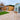 Backyard with wooden shed, patio, and garden furniture on a clear day.