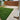 Backyard with a grassy area, paved patio, and wooden bench.
