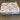 Stack of bags with visible branding on a pallet on a concrete floor.