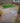 Backyard with paved patio, grass area, and house exterior