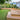 Wessex® Verde Evolved Composite Decking, Oak; patio with steps with turf in back garden
