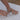 Person using a tool on a white core drive grid with gravel