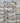 Stack of gray stone slabs used for wall construction.