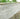 umbra kandla grey Stone wall with garden plants at the top