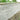 umbra kandla grey Stone wall with garden plants at the top