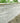 umbra kandla grey Stone wall with garden plants at the top
